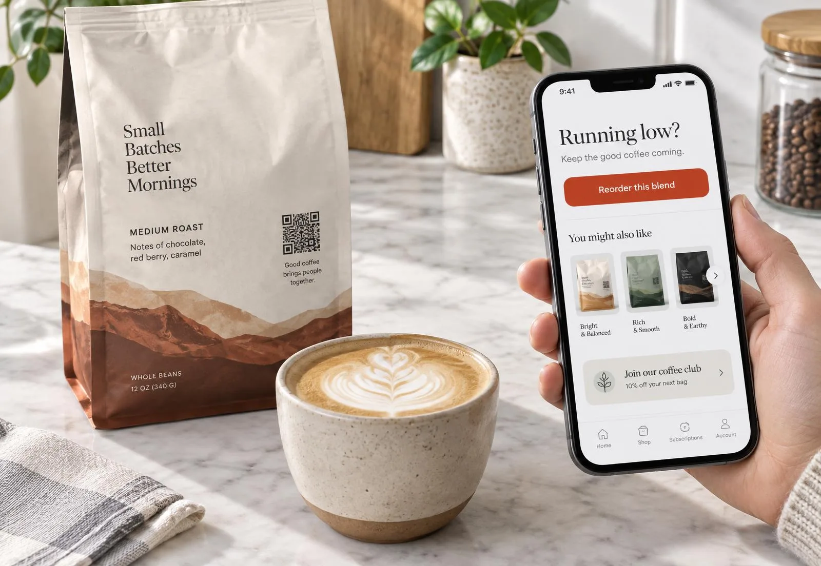 Coffee bag with a QR code beside a phone showing a reorder button, related blends and a coffee club offer